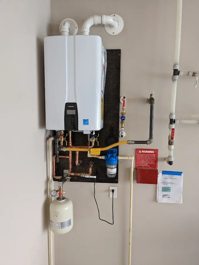 Professional plumber installing copper piping in a Hazel Green home